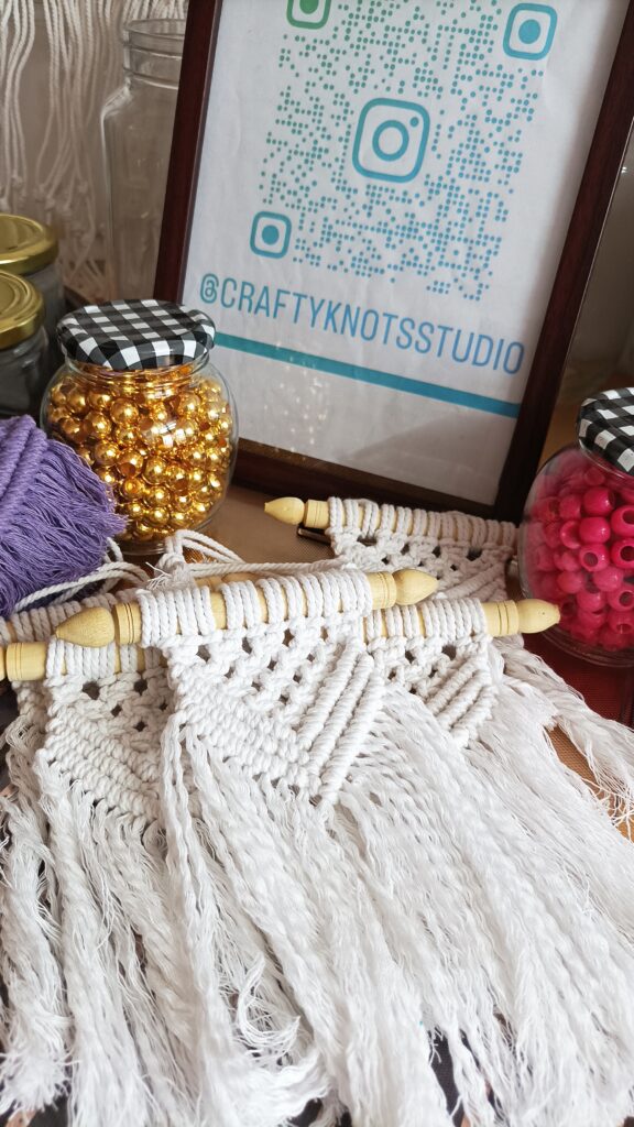 Handmade white macramé wall hanging with wooden dowel by Crafty Knots Studio Goa